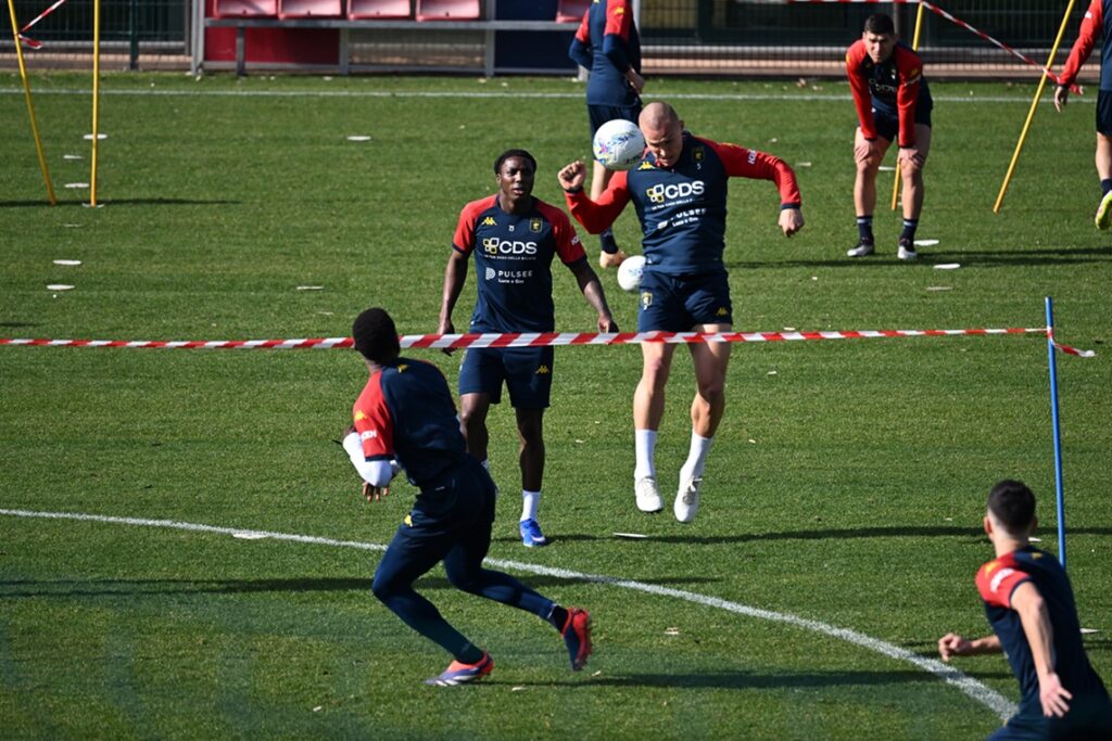 Durante l'allenamento del Genoa, alcuni giocatori rossoblù si esercitano nei duelli aerei in vista della sfida di Cremona allo stadio Giovanni Zini.