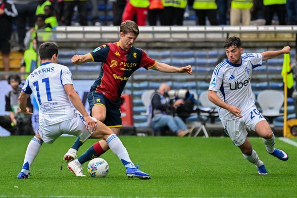 Durante Genoa–Como al Luigi Ferraris, Frendrup e Douvikas lottano sul campo verde in una partita con maglie rossoblù e biancoazzurre
